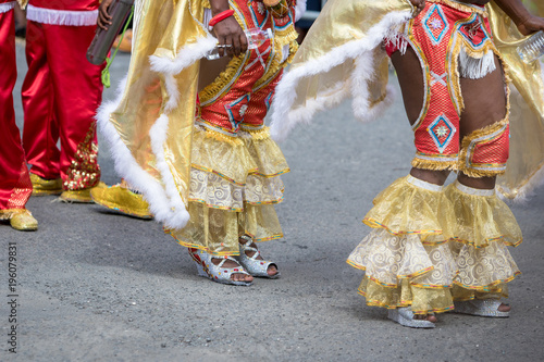 Woman's legs wearing masquerade mask during carnival parade in Guadeloupe, Caribbean photo
