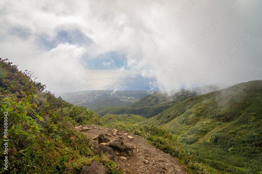 Trail on the active volcano La Soufriere, Guadeloupe, Caribbean. View towards Basse Terre and sea