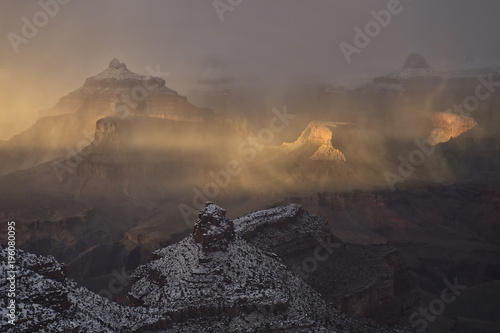 Snow showers over Grand Canyon at sunrise;  Arizona