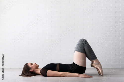 Ballerina practicing on the floor of a dance studio