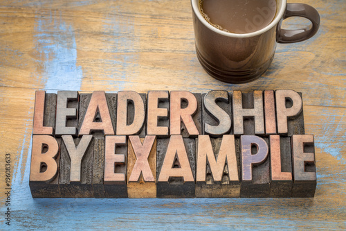 leadership by example - word abstract in wood type