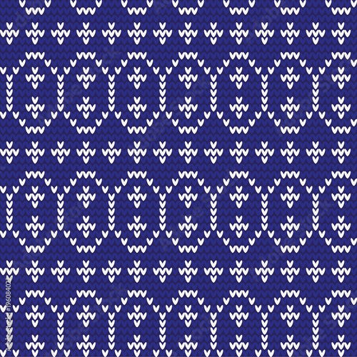 Knitted pattern of Easter eggs white on a blue background. Happy easter Greeting Card. Easter eggs on knitting pattern