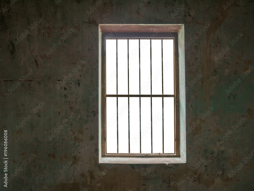 Window with bars against old walls,isolated on white background with clipping path for background images. Window with bars against old walls,isolated on white background with clipping path for background images.