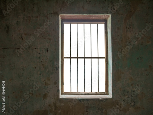 Window with bars against old walls,isolated on white background with clipping path for background images.