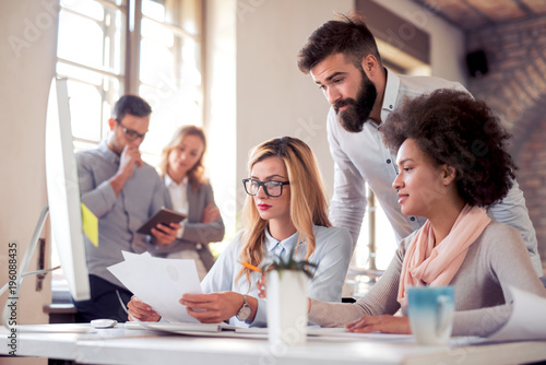 Young business people working together in modern office.