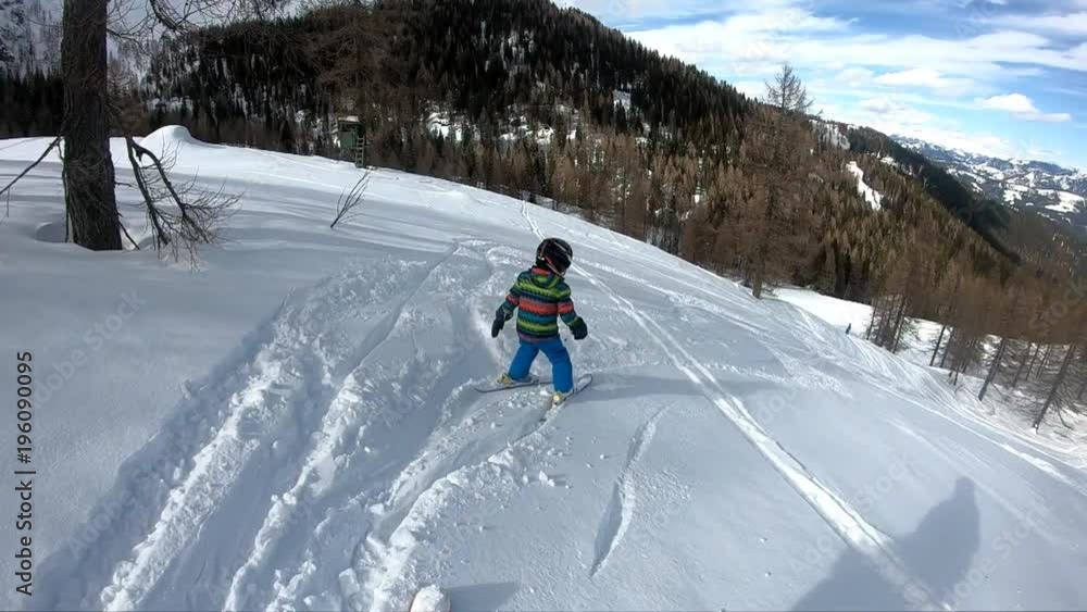 Freeride skiing. Little boy skiing in the wild. Skiing down. A 5 year old child enjoys a winter holiday in the Alpine resort. Stabilized shot. Slow motion.
Freeride skiing. Little boy skiing in the wild. Skiing down. A 5 year old child enjoys a winter holiday in the Alpine resort. Stabilized shot. Slow motion.
