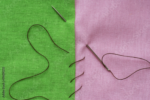 green and pink piece of fabric sewn with a needle