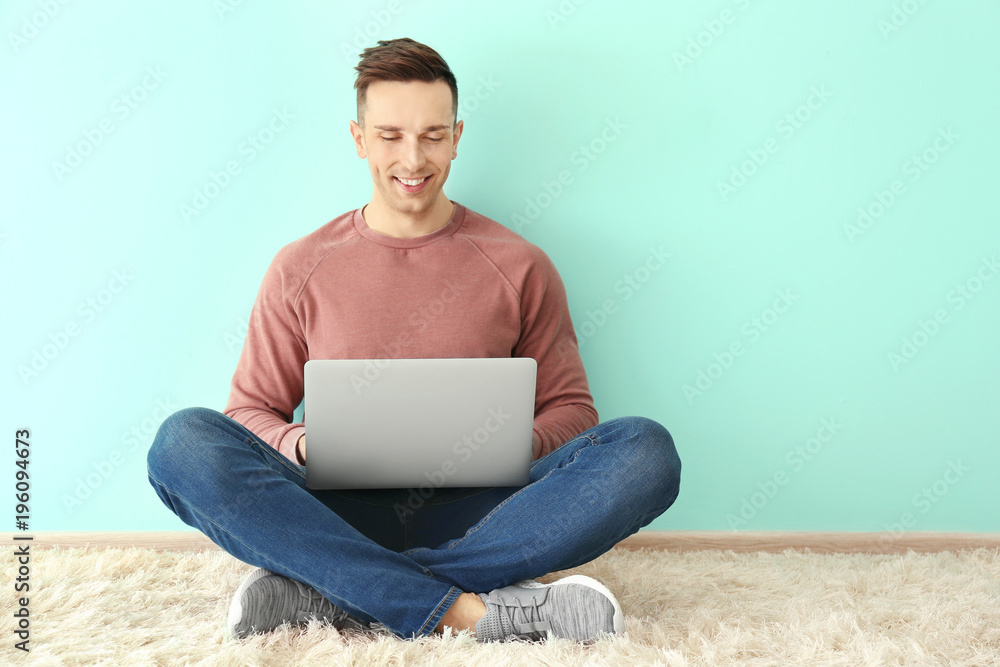 Young man using laptop indoors Young man using laptop indoors