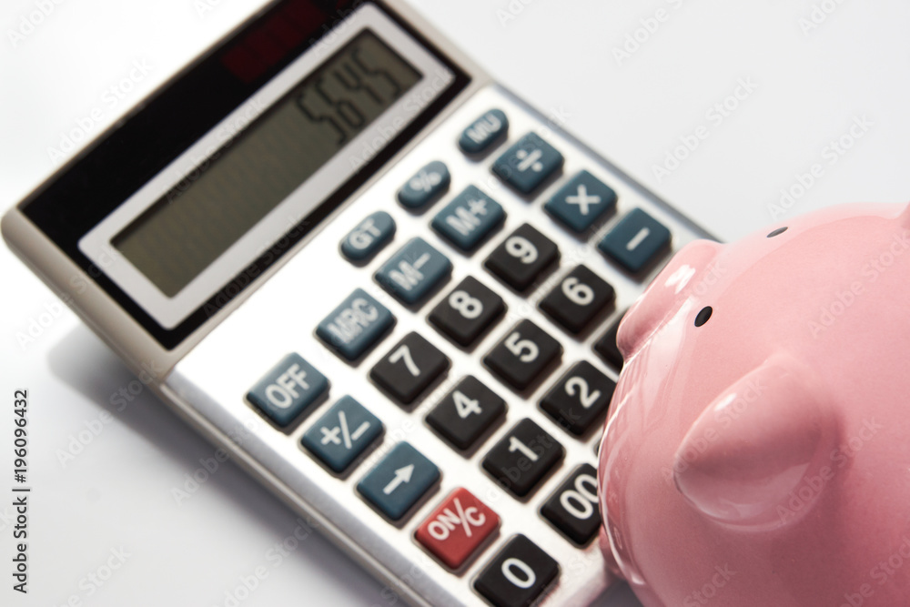 Piggy Bank with calculator on white background, concept for calculating finance savings