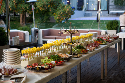 Buffet served table with snacks,fruits,canape,sweets and appetizers.Catering event plate service.Smorgasbord,food choice of breakfast in restaurant photo