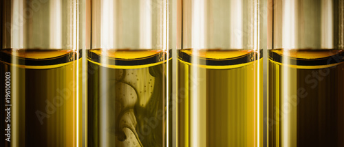 yellow liquid machine oil in glass tubes