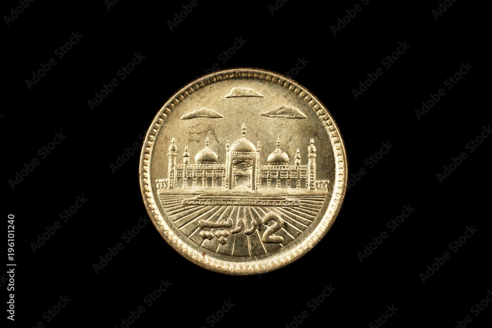 A super macro image of a 2 Pakistani rupee coin isolated on a black background A super macro image of a 2 Pakistani rupee coin isolated on a black background