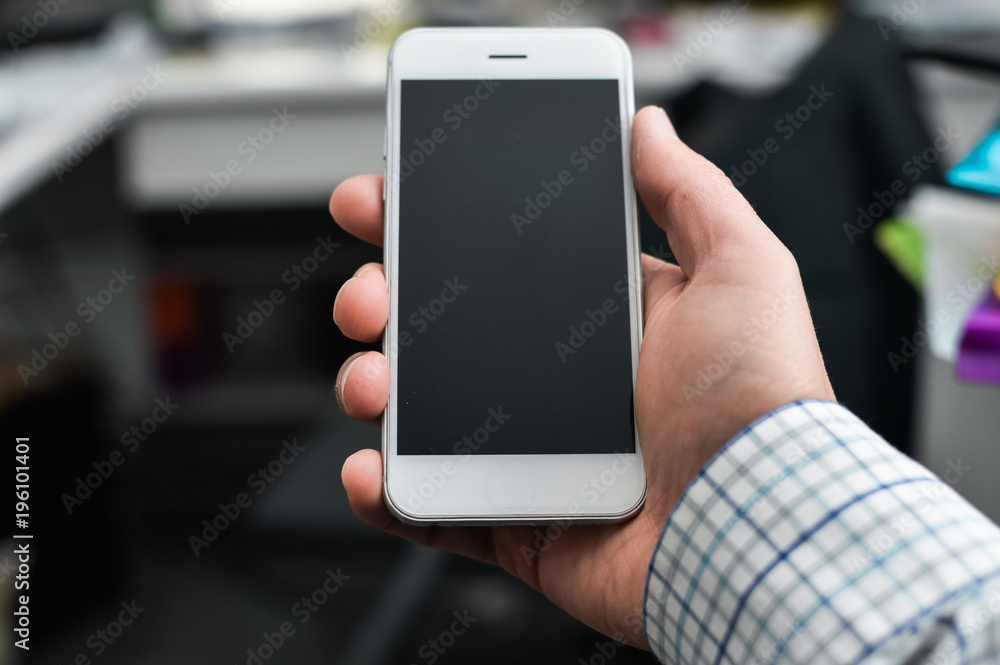 Businessman using mobile phone on light background for photo or video. Writing text, checking calls, reading messages. Close up picture of communication technology device