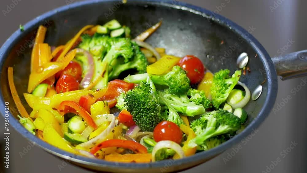 Stir fry vegetables cooking in a fry pan, slow motion video Stir fry vegetables cooking in a fry pan, slow motion video