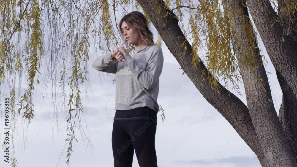 Woman jogging stops to strech and rest for a second then continues on. Woman jogging stops to strech and rest for a second then continues on.
