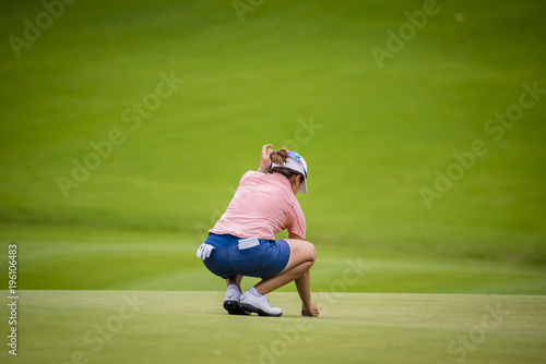 golfer checking line of fairway for teeing golf to hole on golf course
