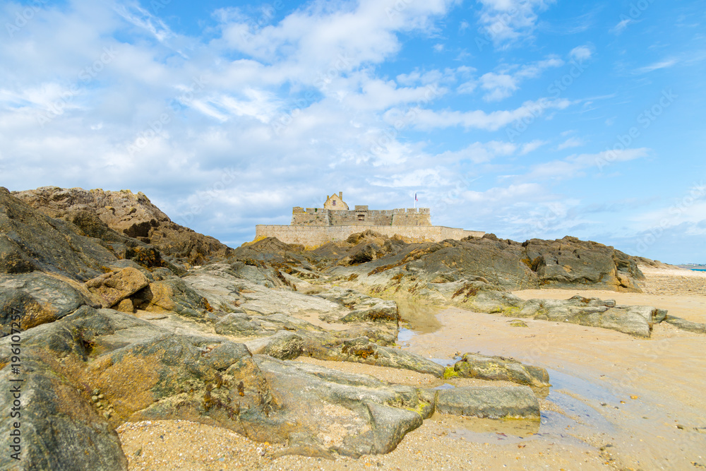 Low view of Saint Malo beach, Fort National and rocks during low Tide. Brittany, Europe