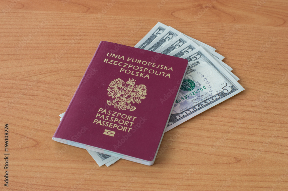 Polish biometric passport with five dollars banknotes. Polish biometric passport with five dollars banknotes.