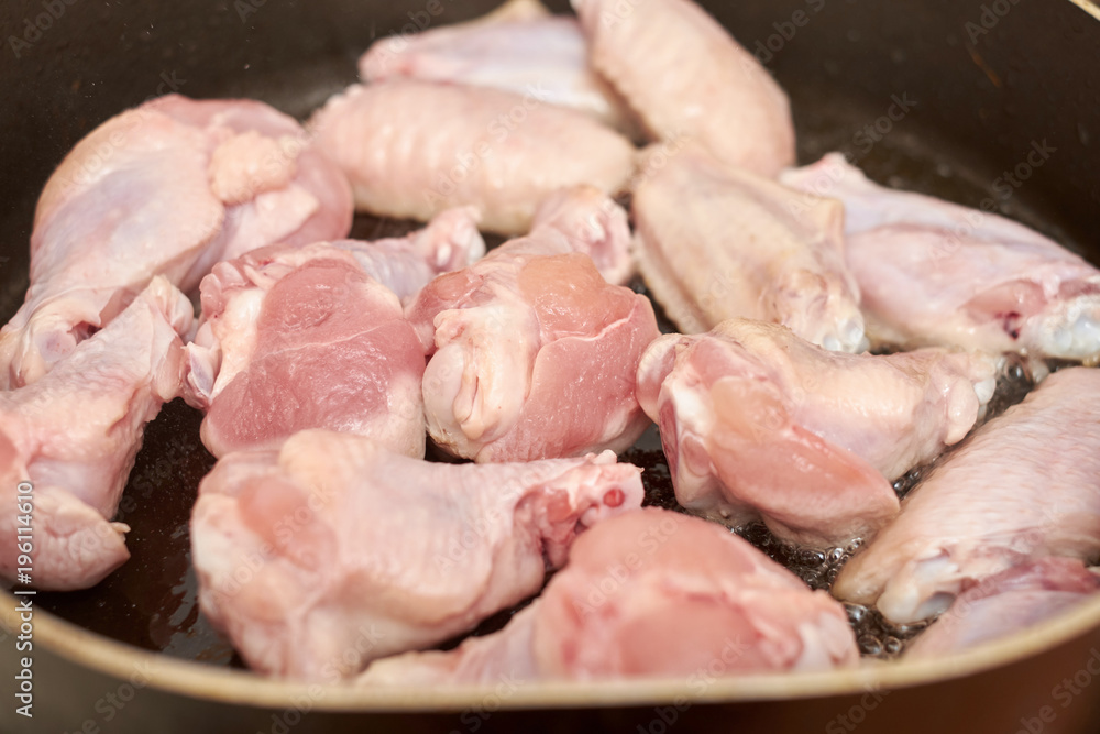 Chicken wings fried in pan with hot oil, homemade food Chicken wings fried in pan with hot oil, homemade food