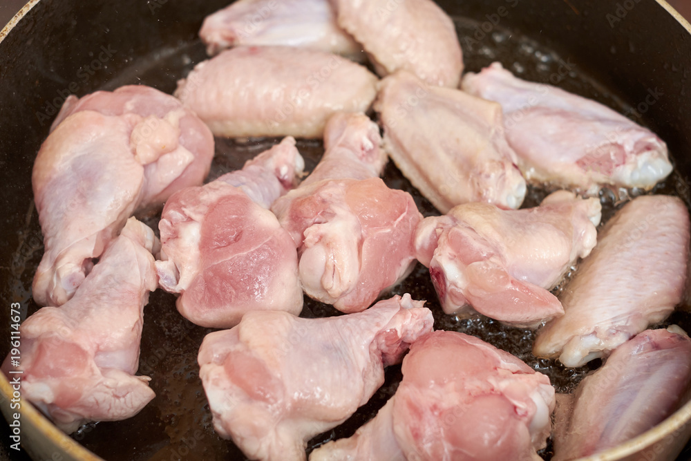 Chicken wings fried in pan with hot oil, homemade food Chicken wings fried in pan with hot oil, homemade food