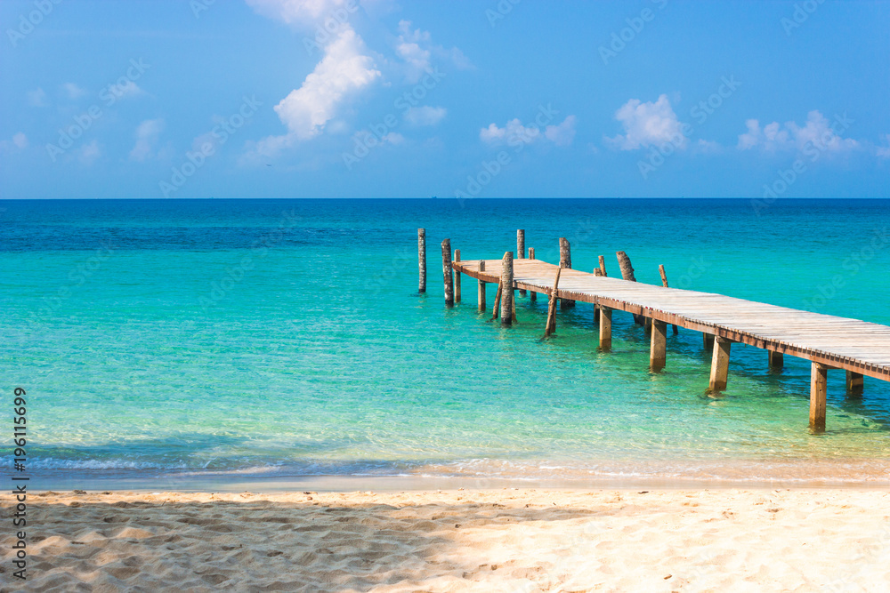 Wooden bridge on the tropical beach and blue sky