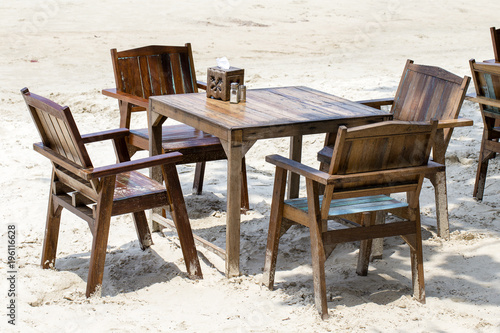 Table and wooden chairs in tropical beach next to the sea   Thailand. Close up