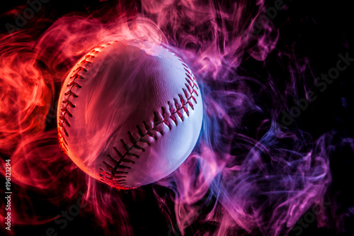 Photography White baseball ball in multi-colored red smoke from a vape on a black isolated b