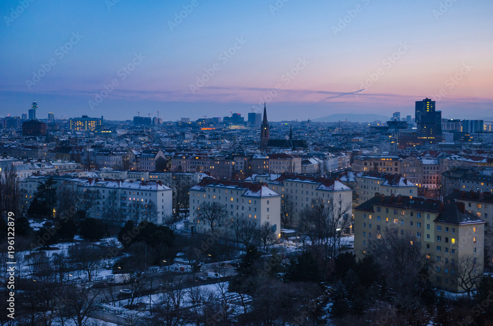 A winter evening sets over Vienna as the sun disappears and the many windows of the city begin to light up