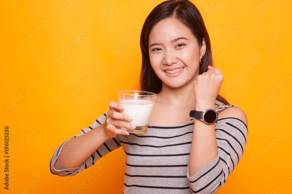 Healthy Asian woman drinking a glass of milk. Healthy Asian woman drinking a glass of milk.