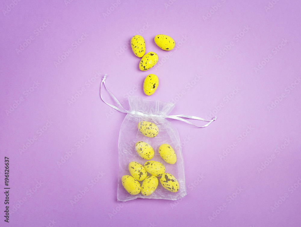 Small yellow eggs in a pouch on a purple background. Small yellow eggs in a pouch on a purple background.