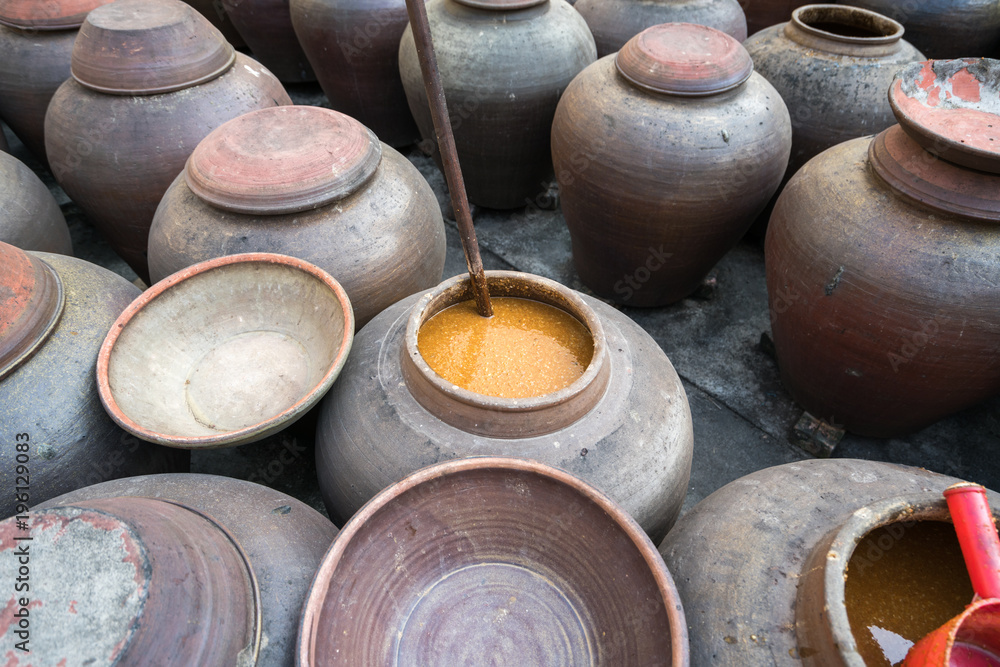 Jars of processing soybean jam made by traditional outdoor way under natural sunlight Jars of processing soybean jam made by traditional outdoor way under natural sunlight