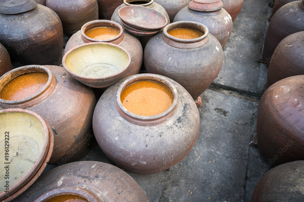 Jars of processing soybean jam made by traditional outdoor way under natural sunlight Jars of processing soybean jam made by traditional outdoor way under natural sunlight