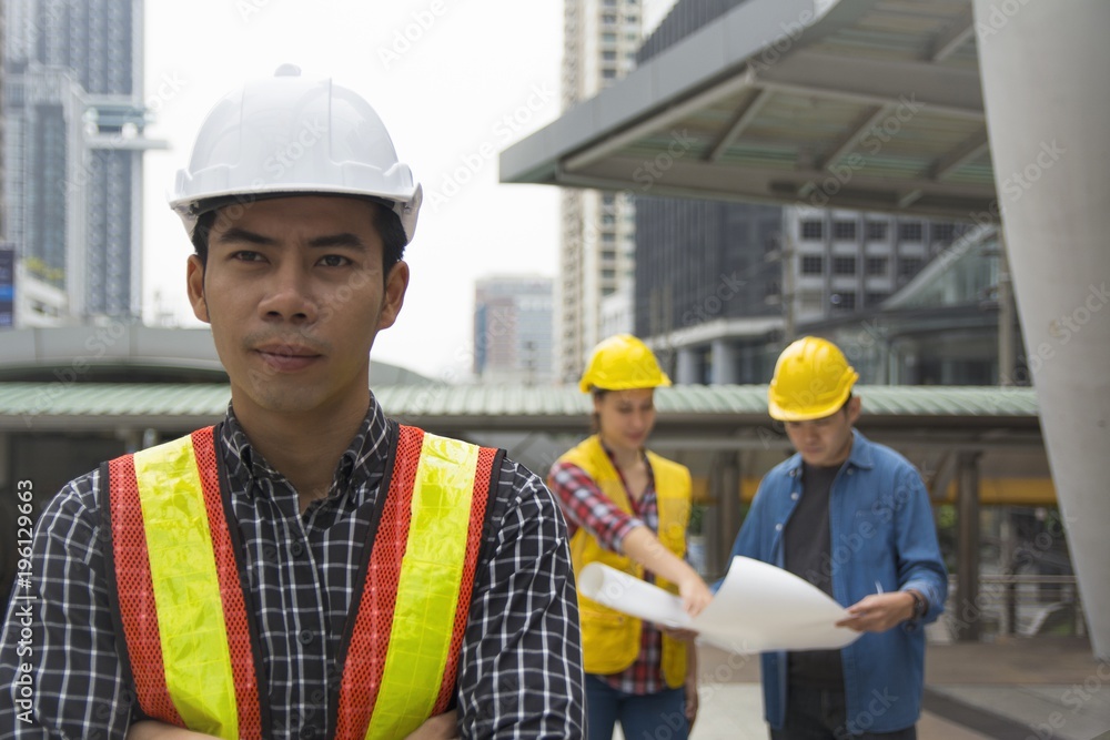 Team of architectures standing at construction site looking at progress. Team of architectures standing at construction site looking at progress.