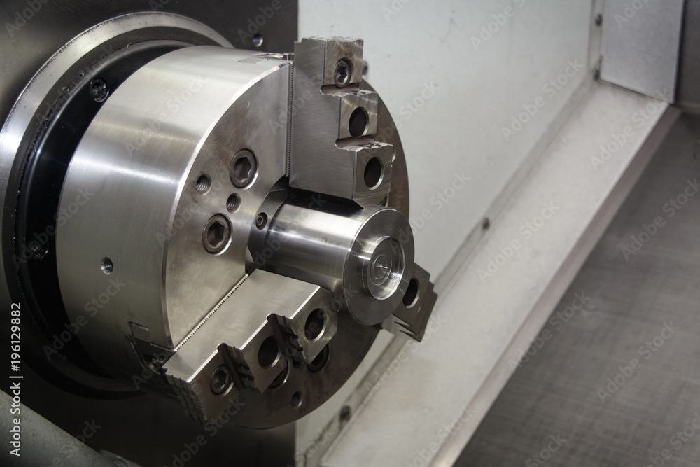 Fototapeta premium Cnc industrial lathe turning spindle chuck and product part on machine
