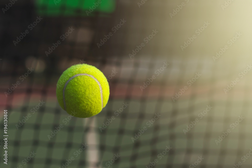 Close up tennis ball hitting to net on blur background