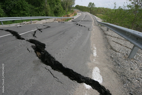 Road collapses with huge cracks. International road collapsed down after bad construction. Damaged Highway Road. Asphalt road collapsed and fallen. Erosion. 