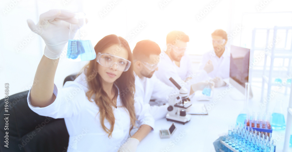 group of young scientists working in the laboratory. group of young scientists working in the laboratory.
