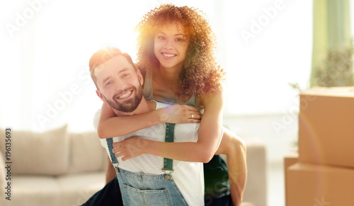 wife hugs her husband in a new apartment.