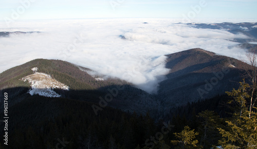 low white clouds in the winter mountains. fog in the canyon