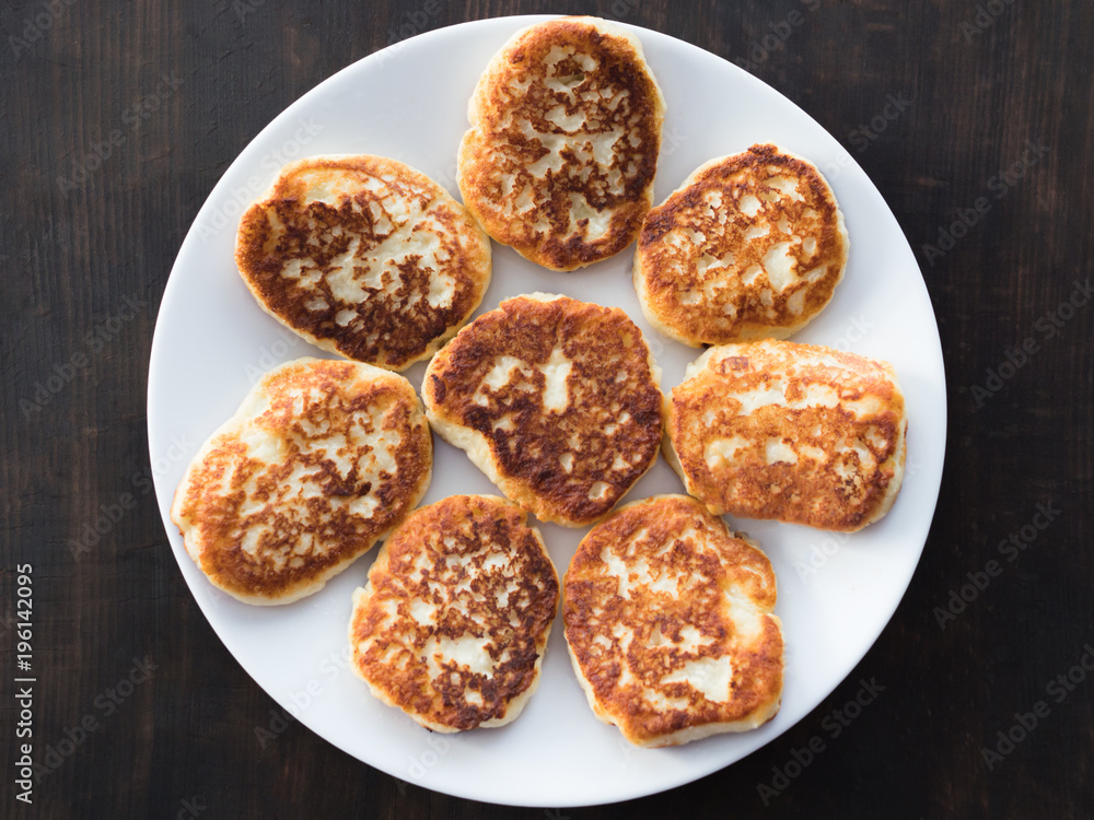 cheese cakes lie on a white plate cheese cakes lie on a white plate