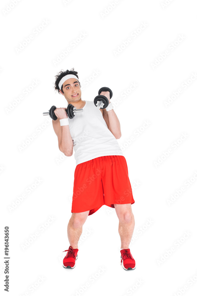 Thin man in headband exercising with dumbbells isolated on white Thin man in headband exercising with dumbbells isolated on white