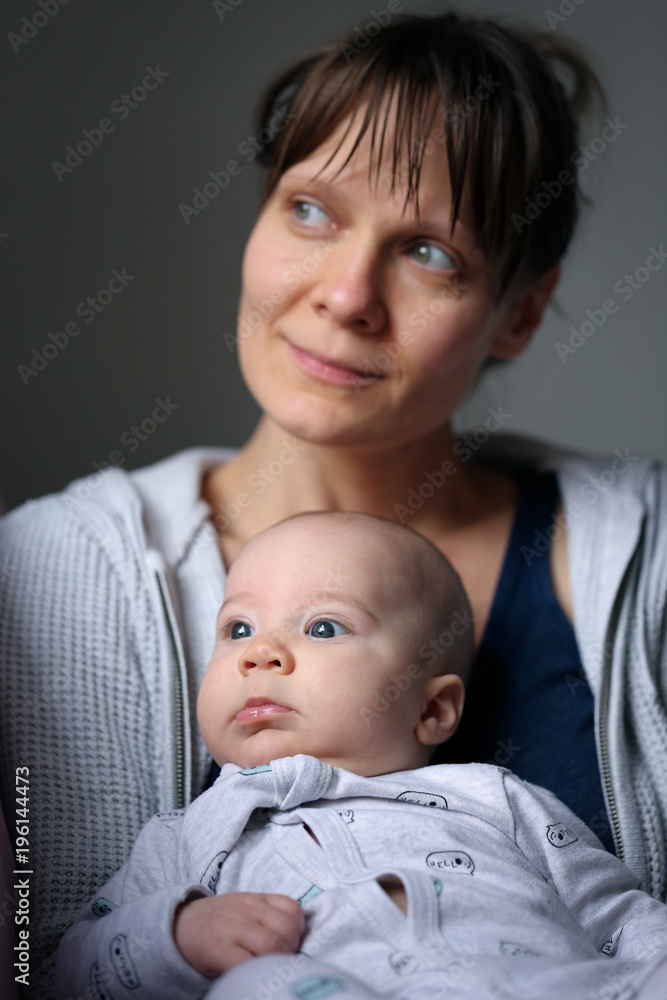 Mom and baby in peace looking out from the window Mom and baby in peace looking out from the window