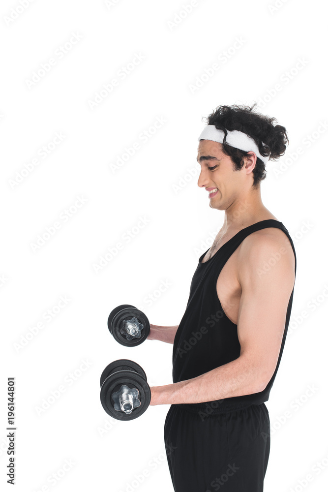 Side view of young skinny sportsman exercising with dumbbells isolated on white Side view of young skinny sportsman exercising with dumbbells isolated on white