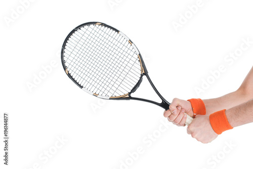 Cropped image of tennis player holding racket isolated on white © LIGHTFIELD STUDIOS