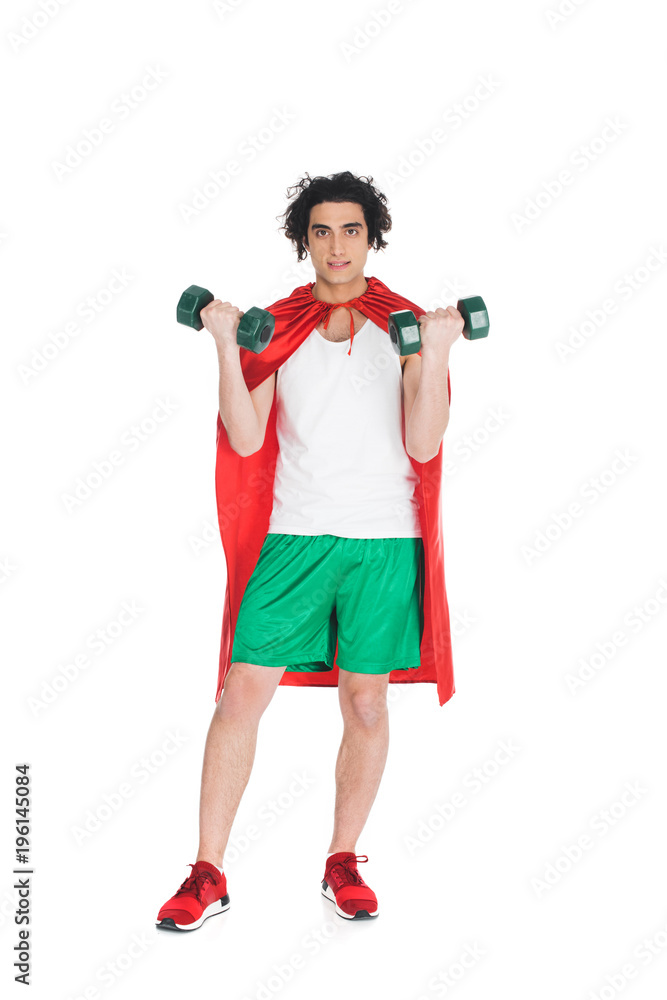 Thin sportsman with dumbbells in hands and wearing red cape isolated on white Thin sportsman with dumbbells in hands and wearing red cape isolated on white