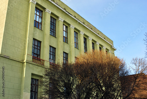 Corner of administrative building with windows , cold snowy sunny winter day, trees without leaves © ArtoPhotoDesigno