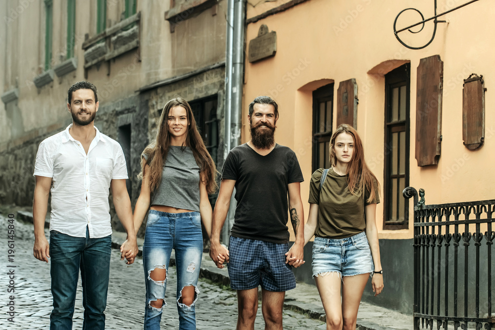 Obraz premium Friends smile on city street, urban style, summer vacation, travel