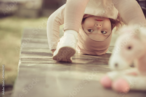 Girl stand on head on sunny day outdoor photo