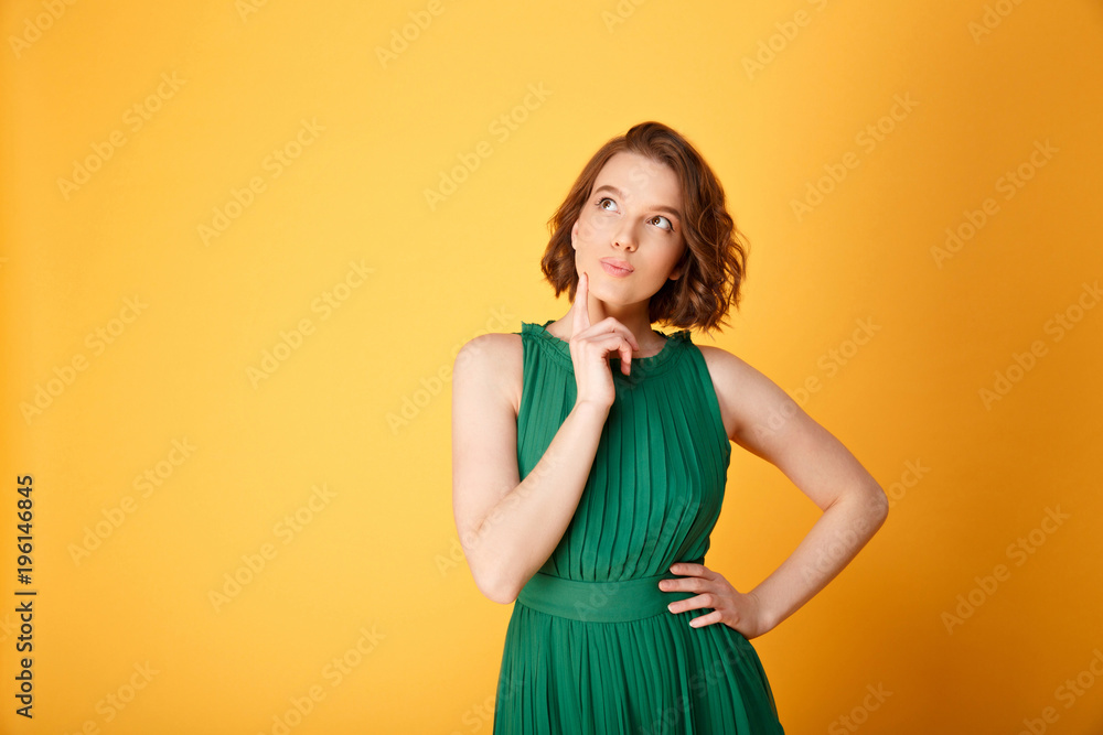 portrait of young thoughtful woman looking up isolated on orange portrait of young thoughtful woman looking up isolated on orange