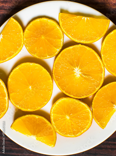 Slices of orange on wood background. top view